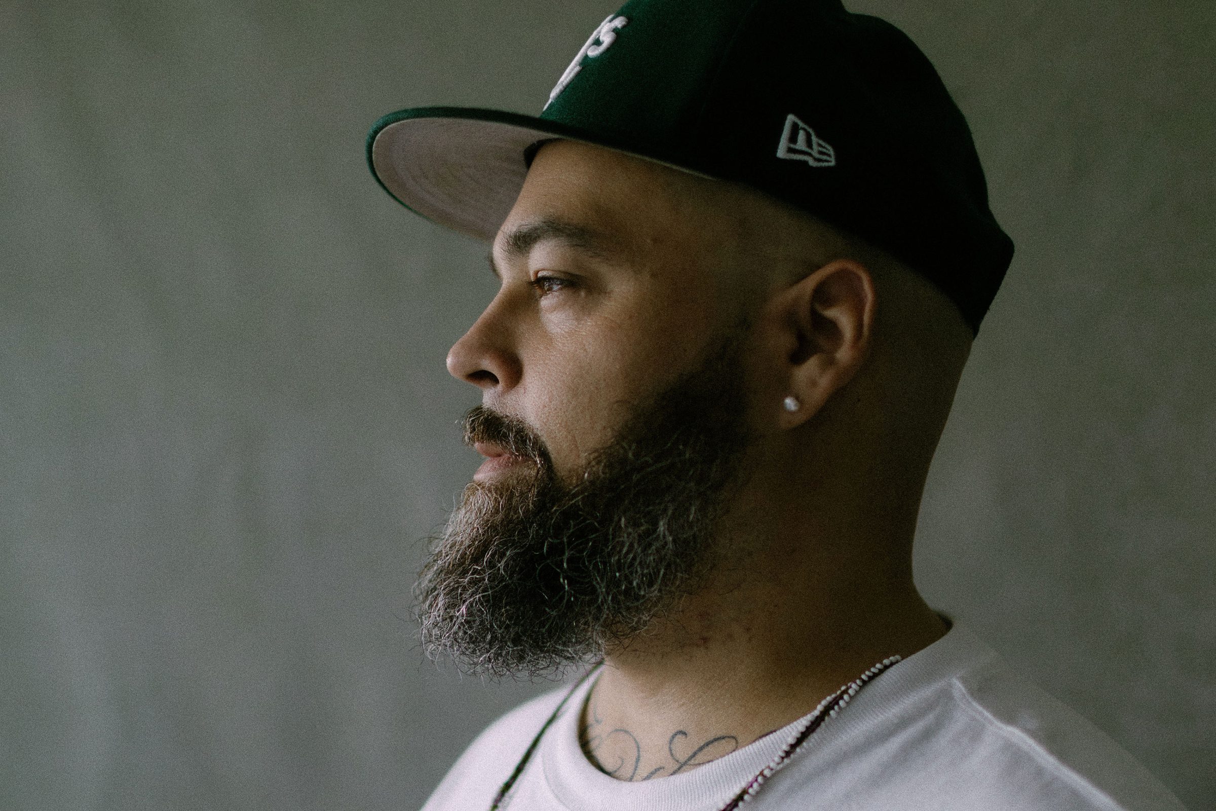 Edrian in profile, green fitted cap